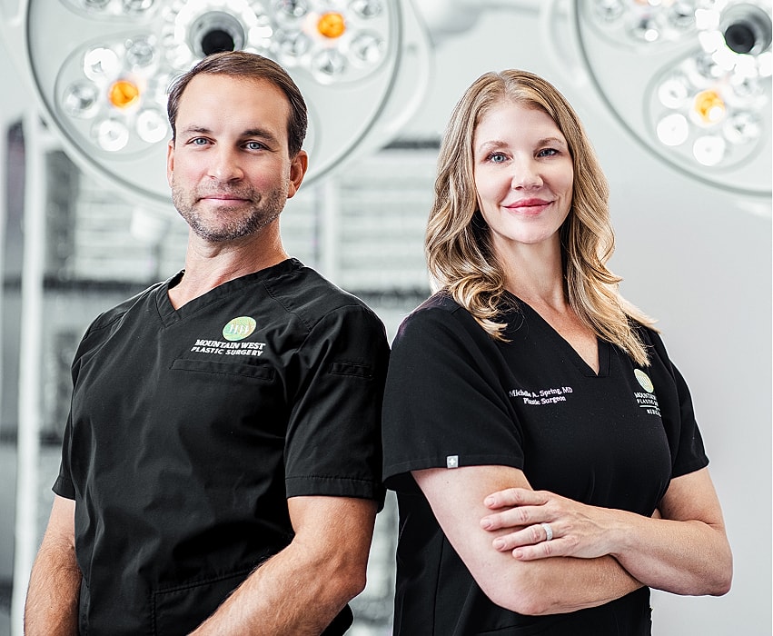 Plastic surgeons in surgical setting, professional portrait.