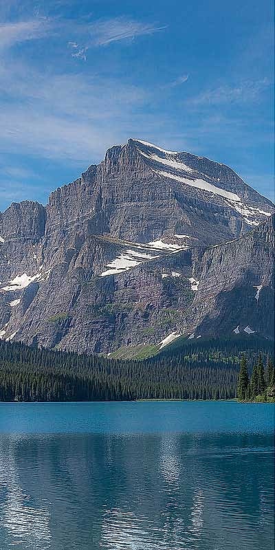 Mountain reflecting in a tranquil blue lake.