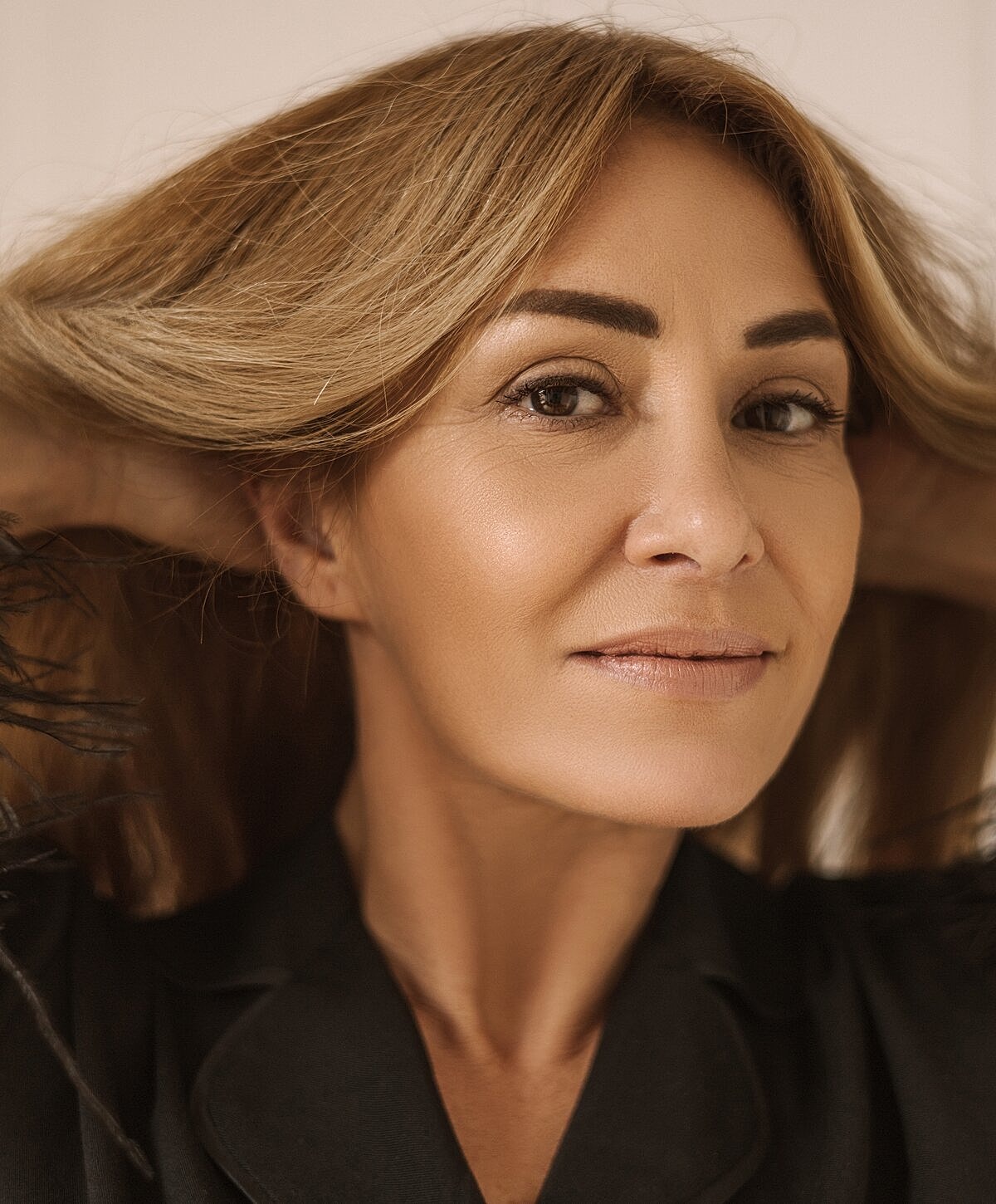 Woman with flowing hair and natural makeup.