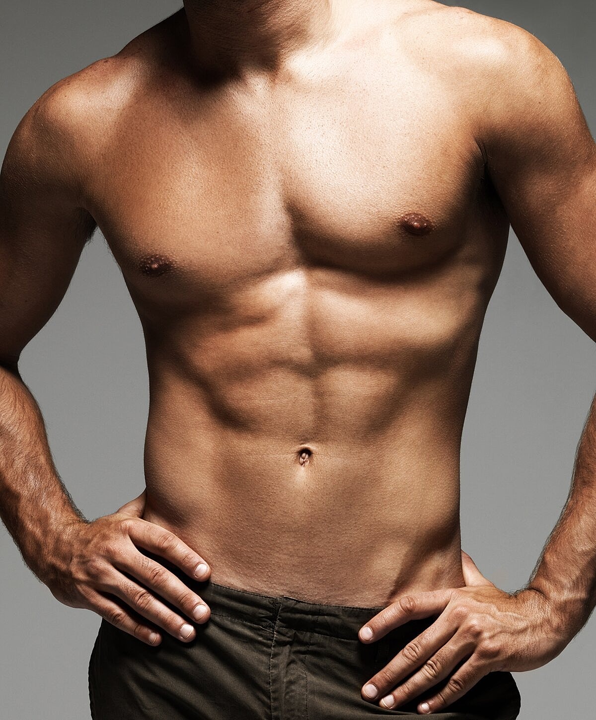 Muscular torso with hands on hips.