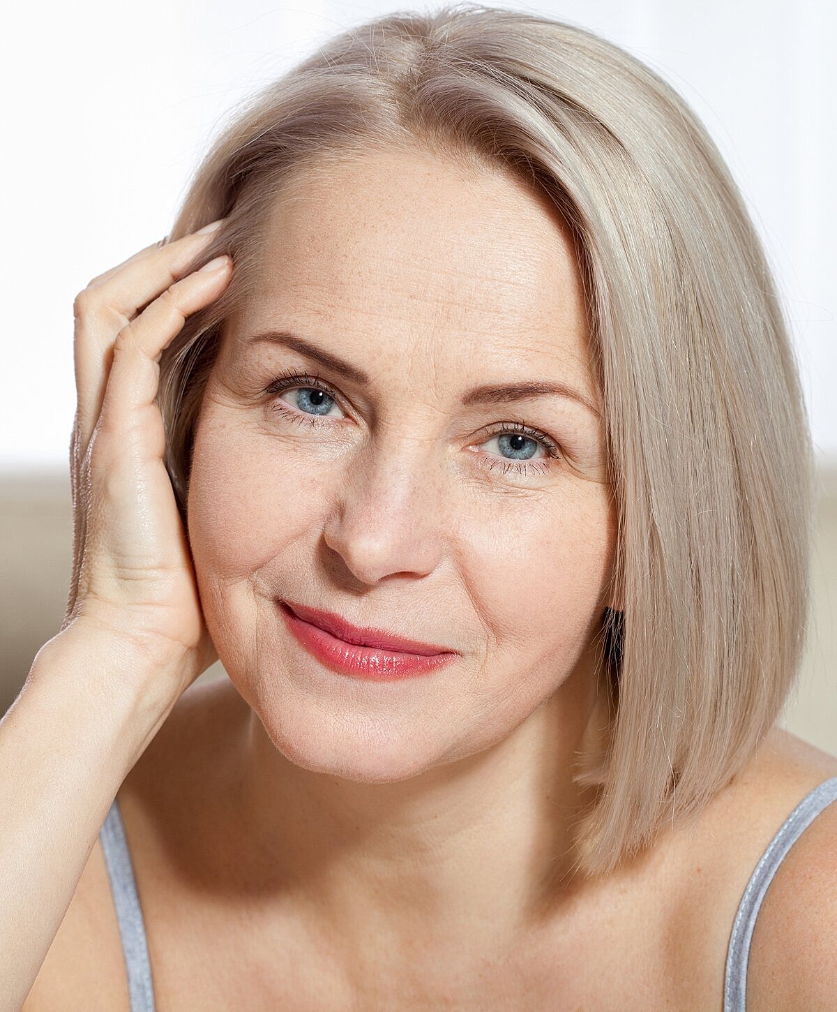 Smiling woman with short, light blonde hair.