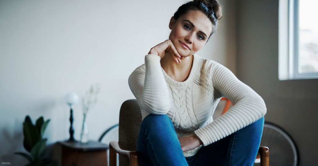 Woman sitting contemplating a Mommy Makeover procedure in Kalispell